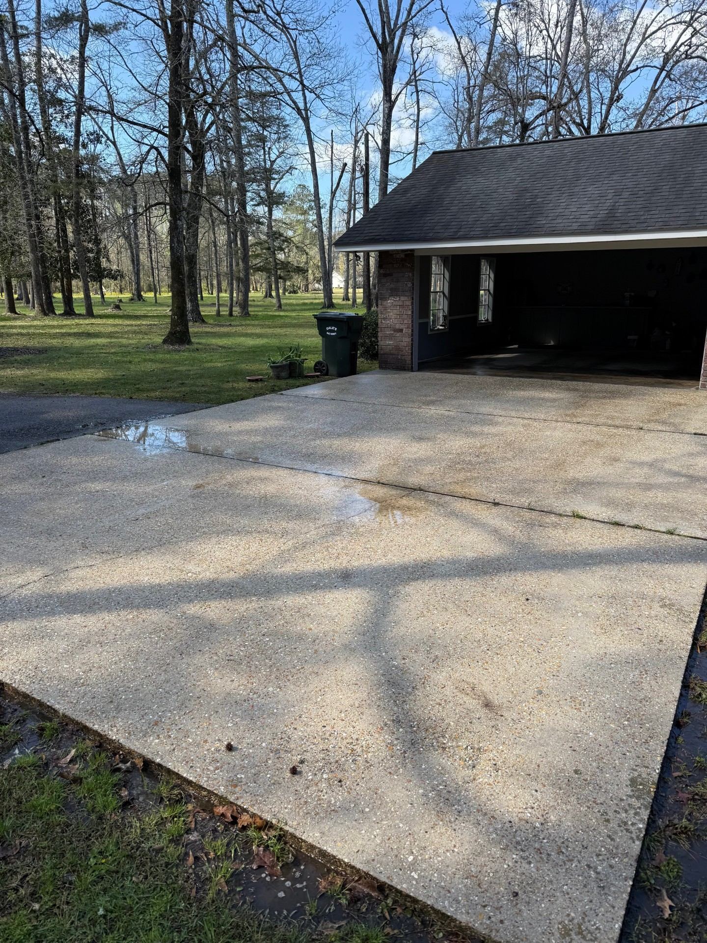 Driveway after pressure washing — clean bright concrete