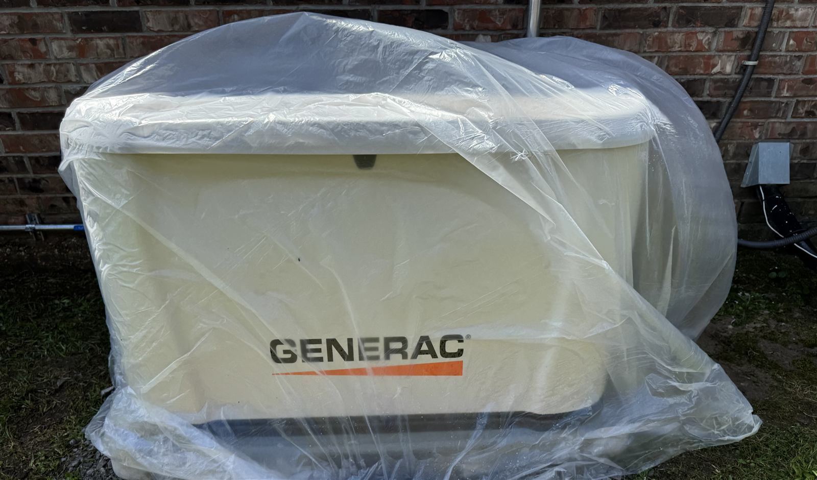 Generac generator wrapped in plastic before soft wash — we protect your equipment