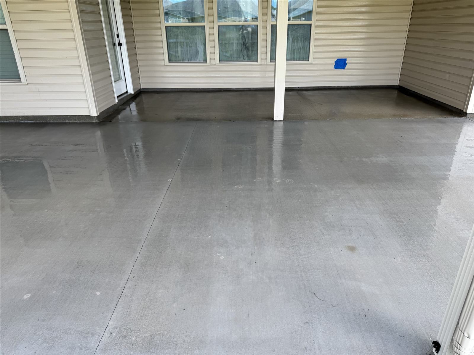 Rear patio concrete after pressure washing — spotless result